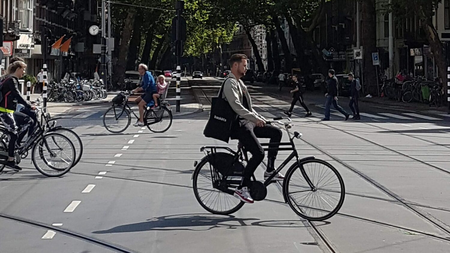 Cyclist commuting near the De Pijp area of  Amsterdam, Netherlands