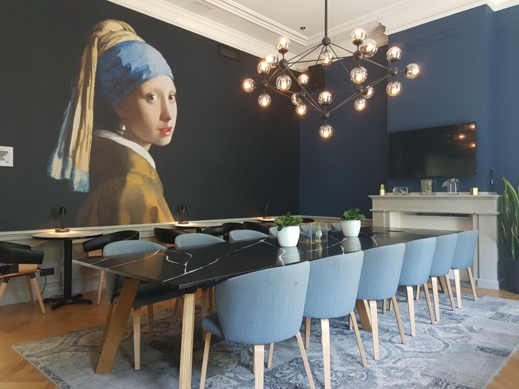 Beautiful breakfast room in the Staybridge The Hague featuring Vermeer's Girl With a Pearl mural