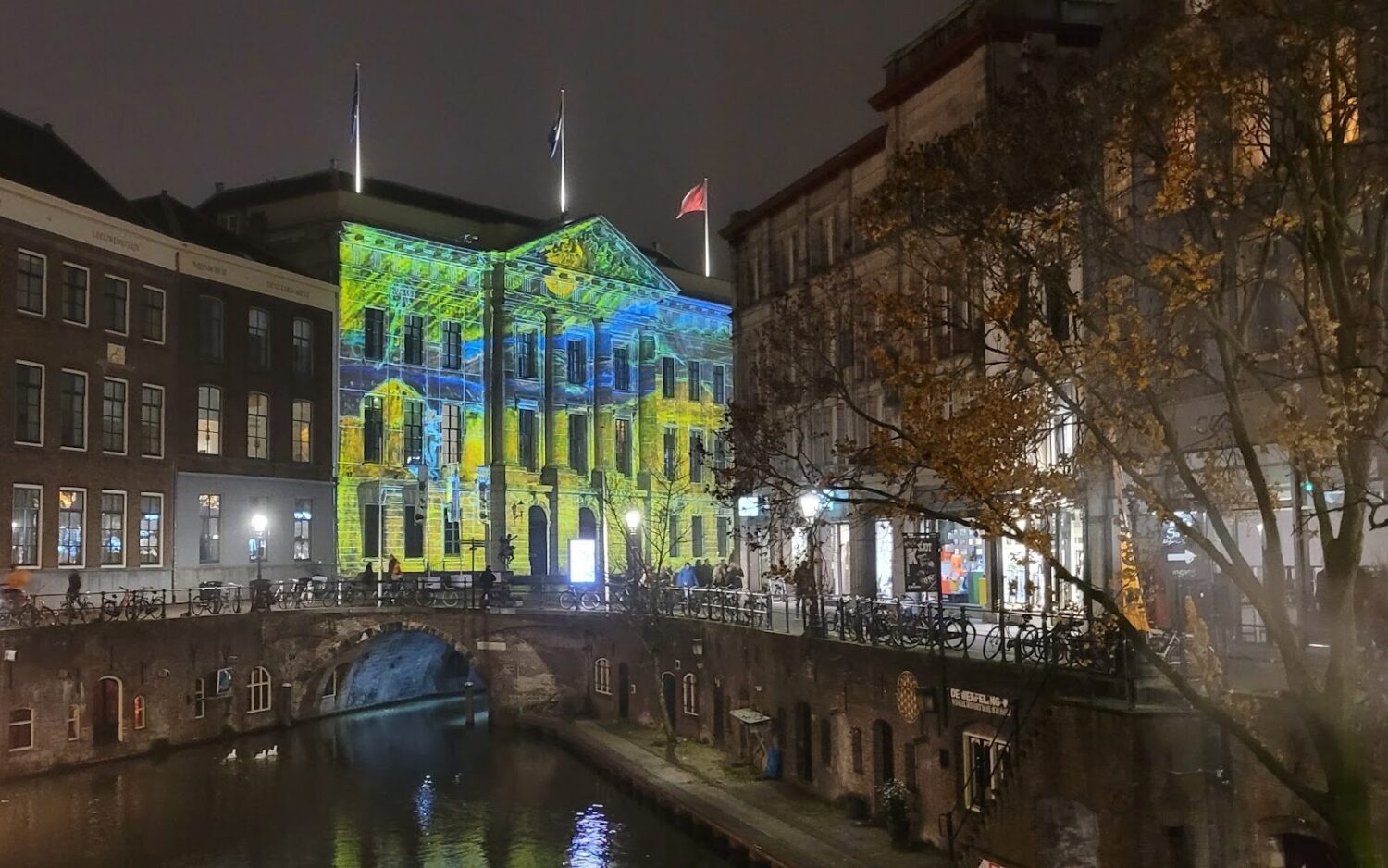 
Utrecht's majestic, historic City Hall at night.  The unique wharf-side restaurants and cafés can be seen at water level