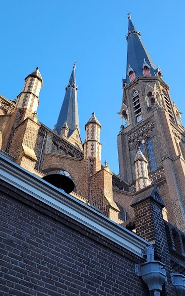 The buttresses and spire of the New Church in Delft in the early morning sunlight