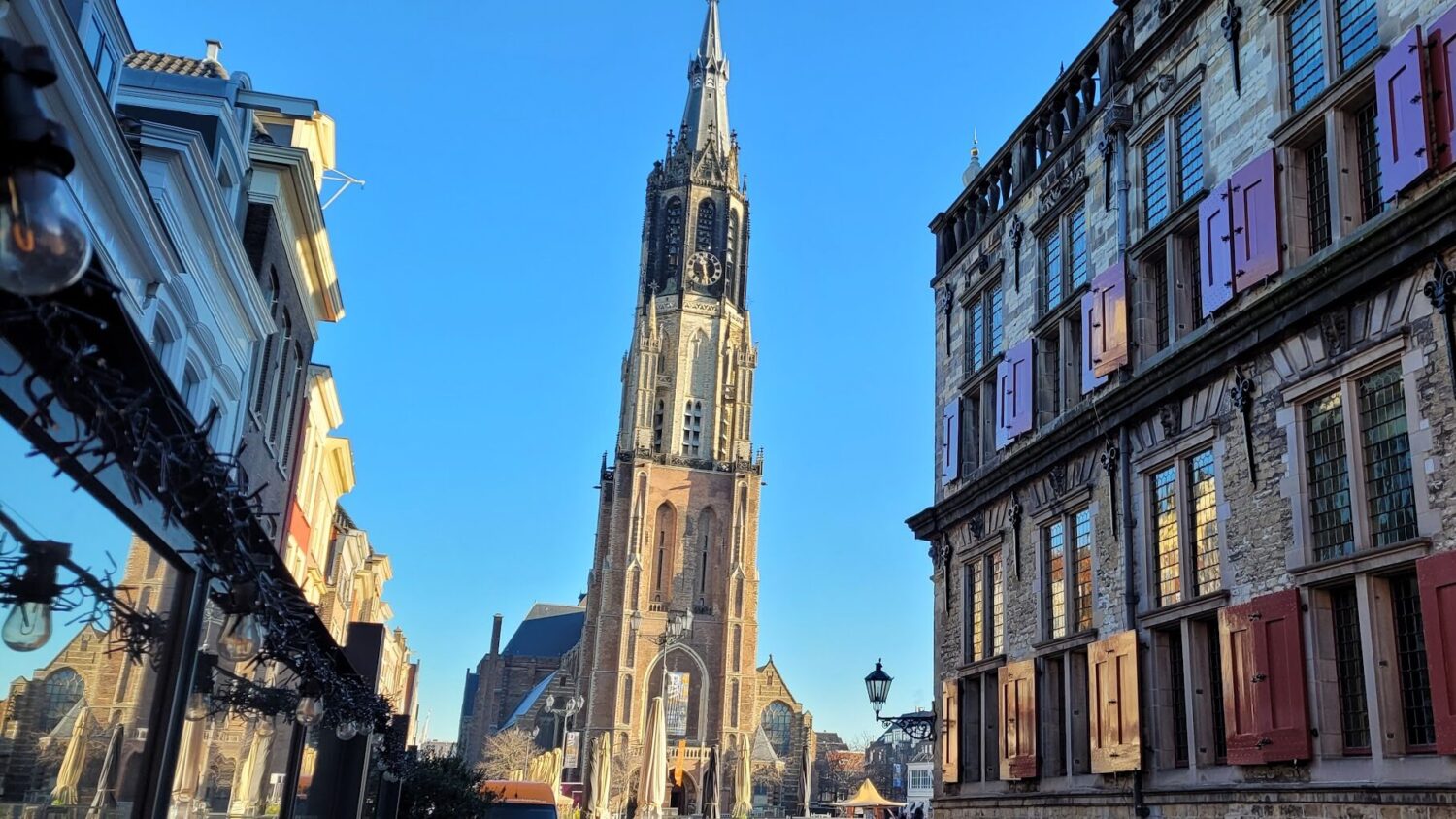Delft's 'Nieuw Kerk' or New Church stands at one end of Delft Market Square with the beautiful 'Stadhuis' or City Hall dating to 1200 AD right.