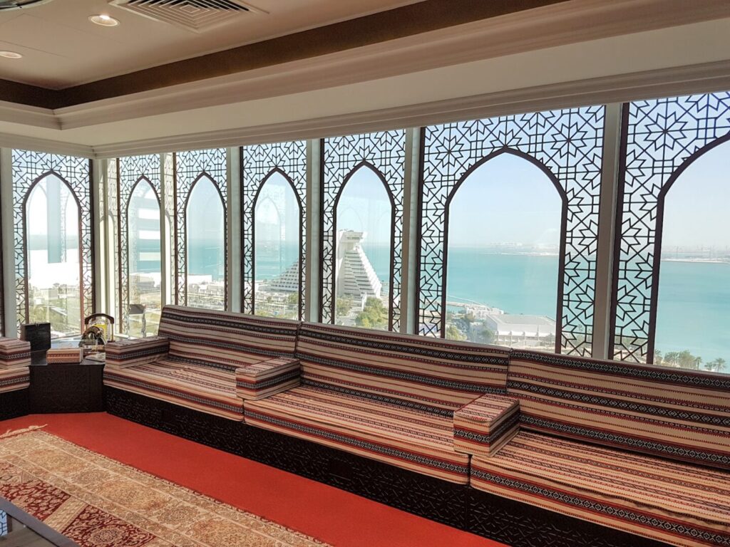 The view of the Persian Gulf on the Arabian Sea and the iconic pyramid-shaped Sheraton Grand Doha Hotel.