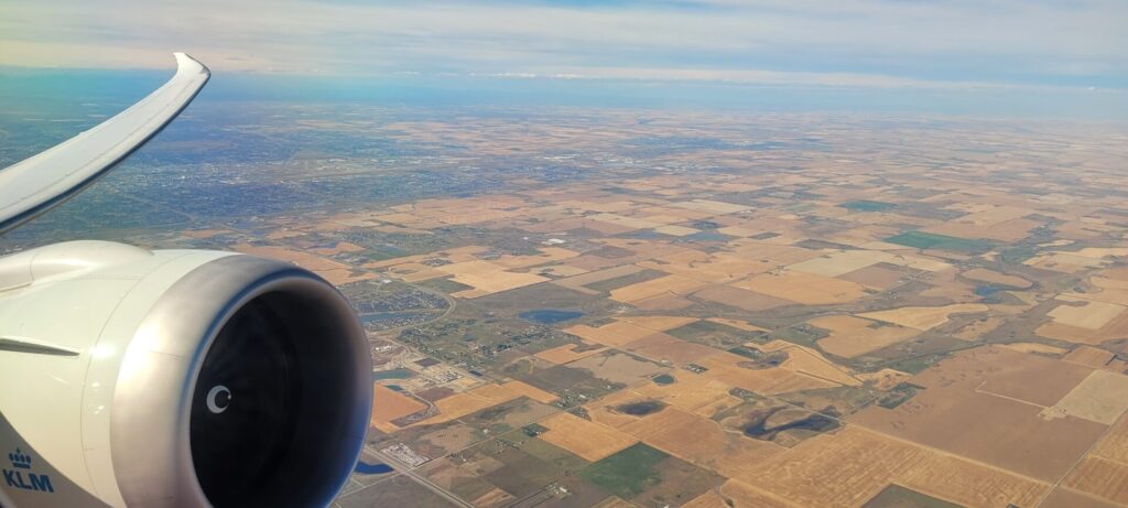 Dreamliner wing and engine in view over the Canadian prairies on our climbout.